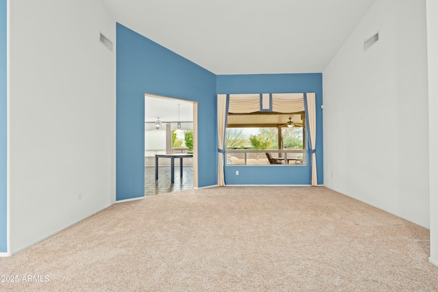 empty room featuring ceiling fan and carpet floors