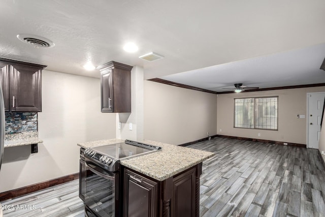 7126 N 19th Ave Unit 228, Phoenix, AZ 85021 - kitchen featuring range with electric stovetop, light wood-style flooring, a ceiling fan, dark brown cabinetry, and decorative backsplash