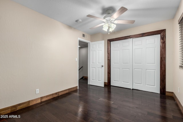 7126 N 19th Ave Unit 228, Phoenix, AZ 85021 - unfurnished bedroom with dark wood finished floors, a closet, and a ceiling fan