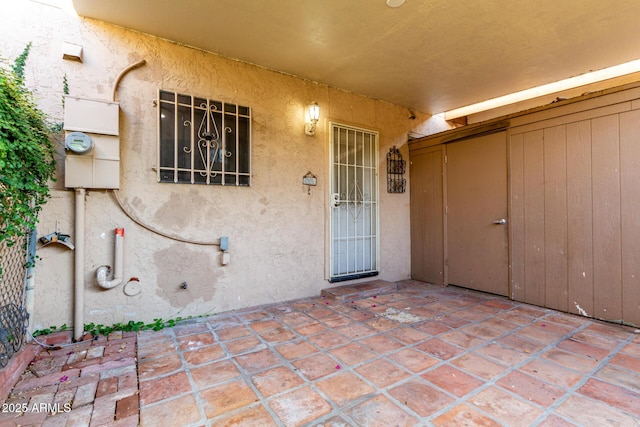 7126 N 19th Ave Unit 228, Phoenix, AZ 85021 - property entrance with stucco siding and a patio area