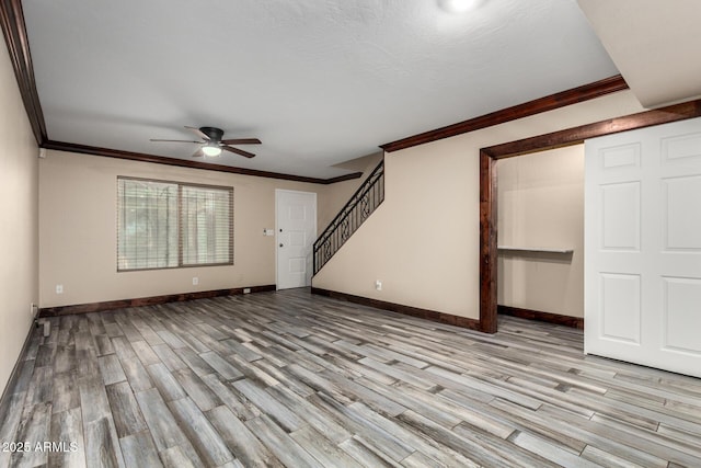7126 N 19th Ave Unit 228, Phoenix, AZ 85021 - unfurnished living room with a ceiling fan, wood finished floors, crown molding, and stairway
