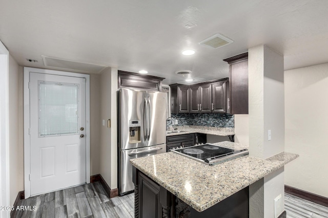 7126 N 19th Ave Unit 228, Phoenix, AZ 85021 - kitchen featuring stainless steel fridge, dark brown cabinets, light wood-type flooring, light stone counters, and cooktop
