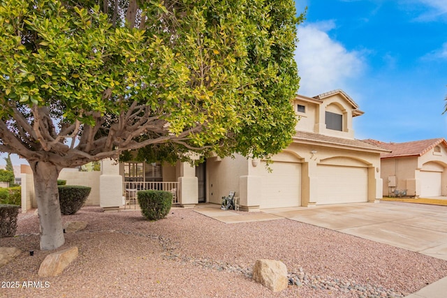 view of front of house featuring a garage, driveway, a tiled roof, and stucco siding