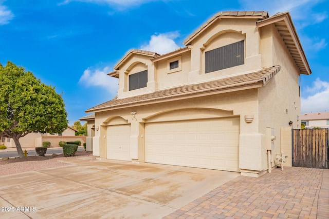 mediterranean / spanish-style home with driveway and stucco siding