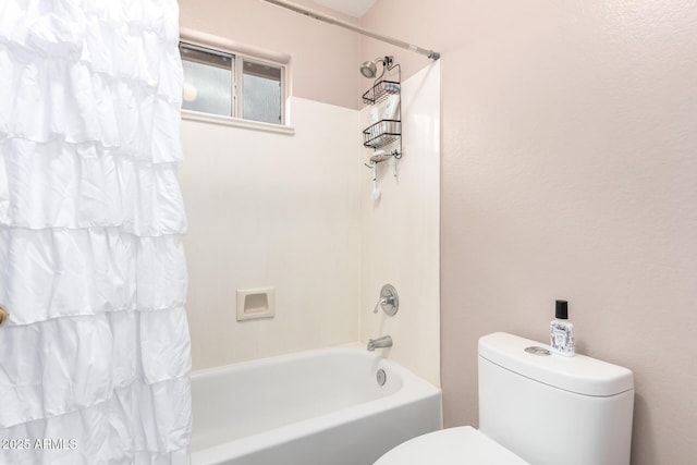 bathroom with shower / bath combination with curtain and toilet