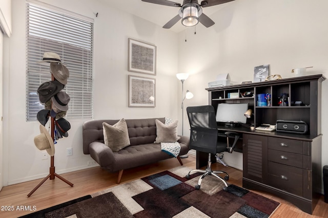 home office featuring ceiling fan, light wood-style flooring, and baseboards