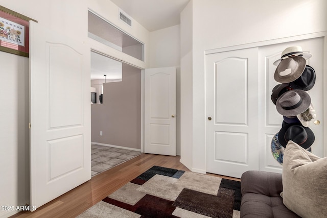 interior space featuring light wood-style floors, visible vents, and baseboards