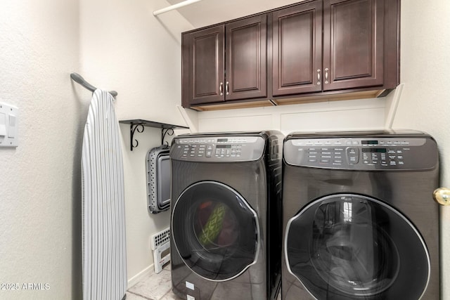 washroom with cabinet space and separate washer and dryer