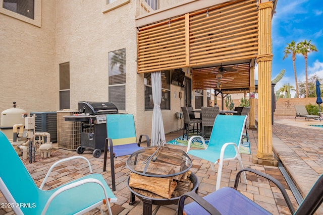 view of patio with a balcony, ceiling fan, fence, and area for grilling