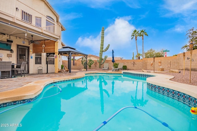 view of pool featuring a fenced in pool, a gazebo, a ceiling fan, a patio area, and a fenced backyard