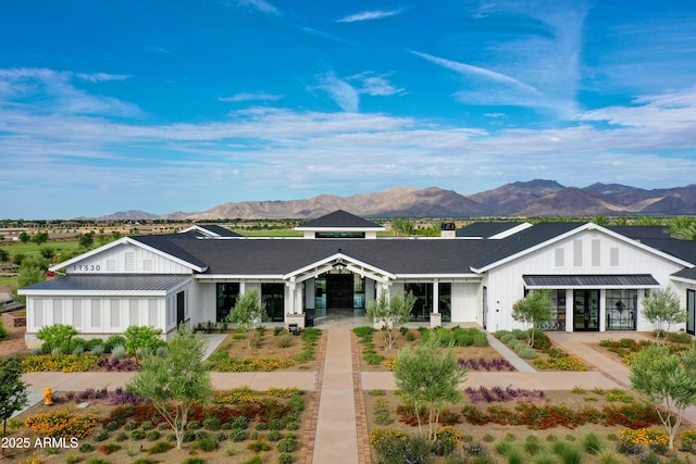 view of front of home with a mountain view, metal roof, a standing seam roof, and board and batten siding