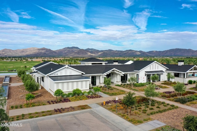 view of front facade featuring metal roof, a residential view, a mountain view, and a standing seam roof