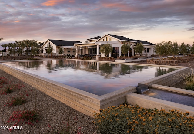 view of pool at dusk