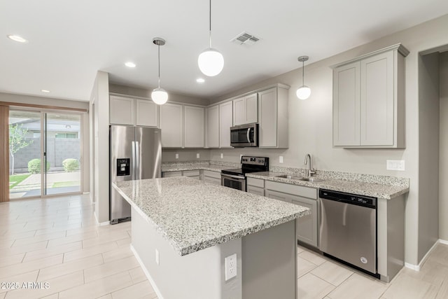9822 W Caron Dr, Peoria, AZ 85345 - kitchen featuring appliances with stainless steel finishes, a sink, light stone countertops, a kitchen island, and recessed lighting
