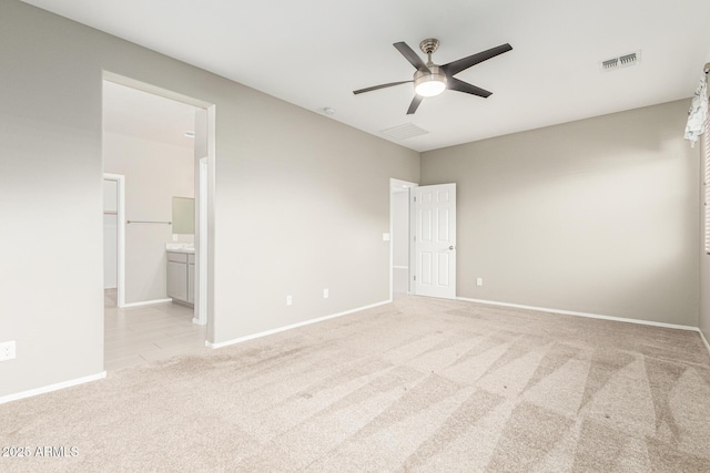 9822 W Caron Dr, Peoria, AZ 85345 - unfurnished bedroom with light colored carpet, baseboards, connected bathroom, and a ceiling fan