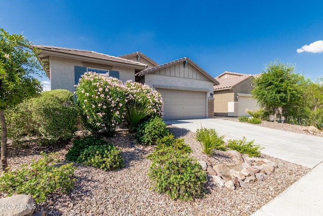 9822 W Caron Dr, Peoria, AZ 85345 - view of front facade featuring a tile roof, driveway, a garage, and stucco siding