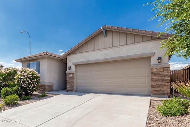 9822 W Caron Dr, Peoria, AZ 85345 - single story home featuring stone siding, board and batten siding, concrete driveway, an attached garage, and stucco siding