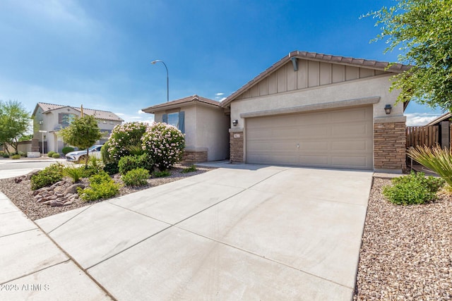 9822 W Caron Dr, Peoria, AZ 85345 - single story home with stone siding, driveway, a garage, stucco siding, and board and batten siding