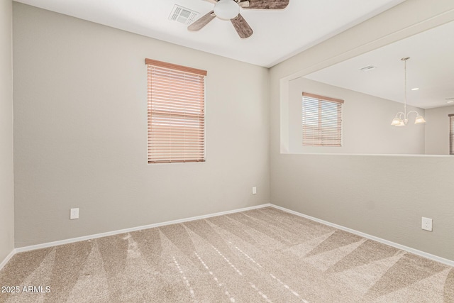9822 W Caron Dr, Peoria, AZ 85345 - spare room with carpet, a ceiling fan, and a chandelier