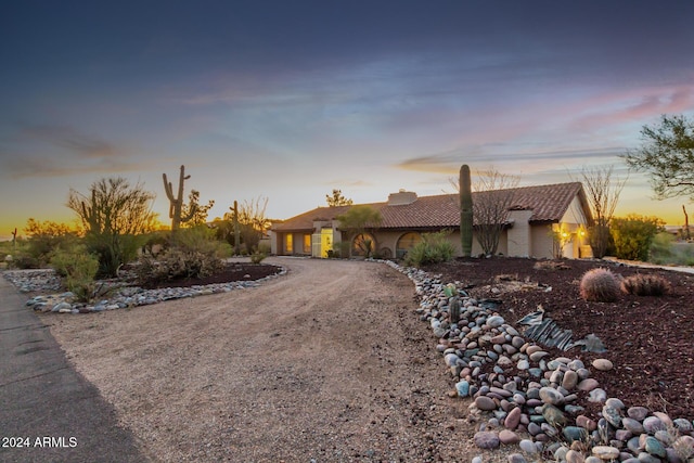36444 N Stardust Ln, Carefree, AZ 85377 - view of front of house featuring curved driveway, a garage, a tiled roof, and stucco siding