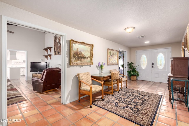 tiled foyer featuring a textured ceiling