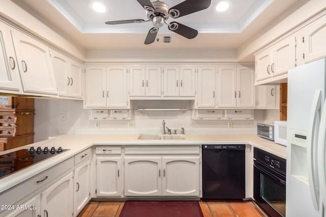 kitchen with black appliances, crown molding, white cabinetry, a raised ceiling, and sink