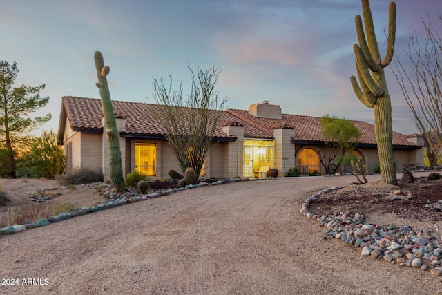36444 N Stardust Ln, Carefree, AZ 85377 - view of front of house featuring a tile roof, a chimney, and curved driveway