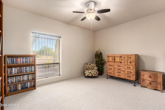 living area featuring carpet flooring and ceiling fan