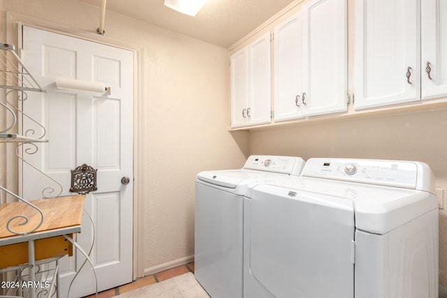 36444 N Stardust Ln, Carefree, AZ 85377 - laundry room with separate washer and dryer, cabinet space, light tile patterned flooring, and baseboards