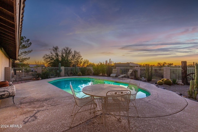 36444 N Stardust Ln, Carefree, AZ 85377 - pool at dusk featuring a patio and a fenced backyard