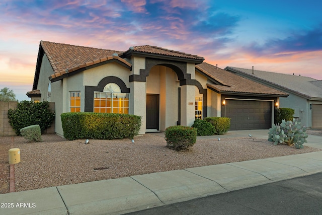 4329 W Electra Ln, Glendale, AZ 85310 - view of front of home with a garage, stucco siding, a tiled roof, and driveway