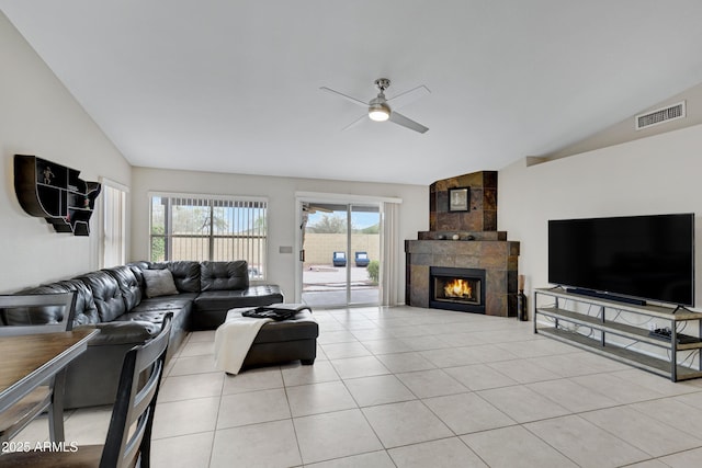 4329 W Electra Ln, Glendale, AZ 85310 - living area with vaulted ceiling, ceiling fan, a tile fireplace, and light tile patterned floors
