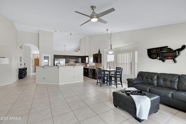 4329 W Electra Ln, Glendale, AZ 85310 - living room with a ceiling fan, arched walkways, light tile patterned flooring, and high vaulted ceiling