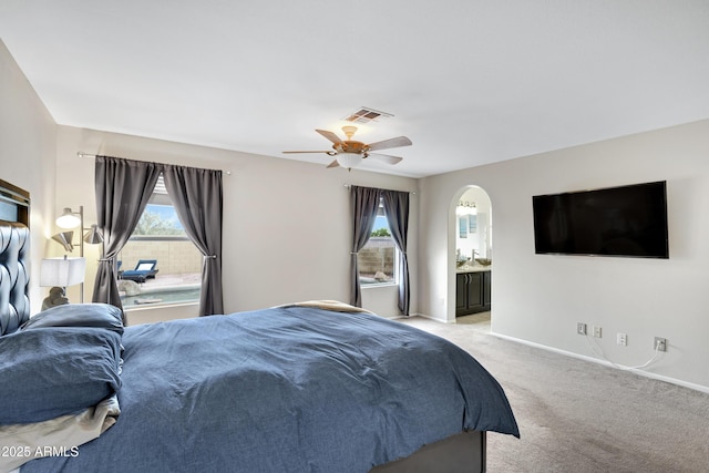 4329 W Electra Ln, Glendale, AZ 85310 - bedroom featuring light colored carpet, baseboards, arched walkways, ceiling fan, and connected bathroom