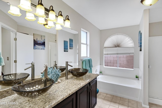 4329 W Electra Ln, Glendale, AZ 85310 - bathroom featuring double vanity, a bath, tile patterned flooring, and a chandelier