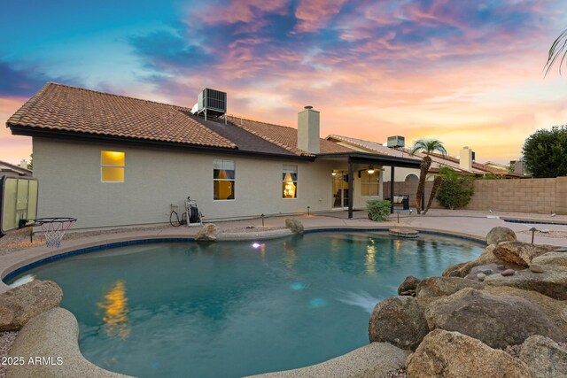 4329 W Electra Ln, Glendale, AZ 85310 - pool at dusk with a patio area and central air condition unit