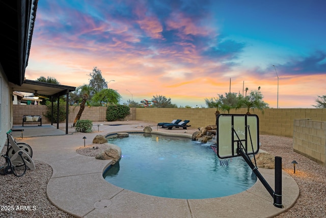 4329 W Electra Ln, Glendale, AZ 85310 - pool at dusk featuring a patio area and a fenced backyard