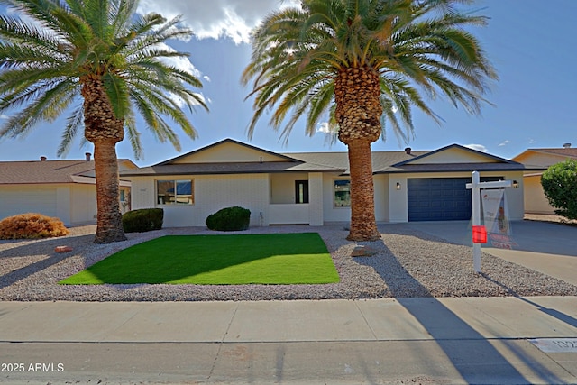 single story home featuring a garage, driveway, and a front yard