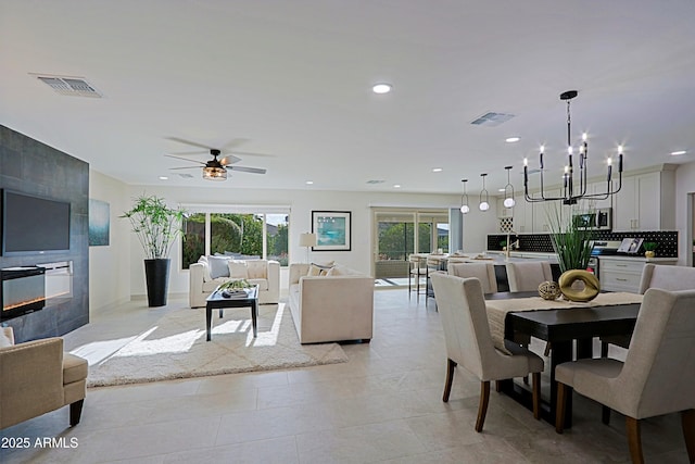 dining space featuring ceiling fan with notable chandelier, visible vents, and recessed lighting