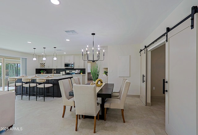 dining room featuring a notable chandelier, a barn door, visible vents, and recessed lighting