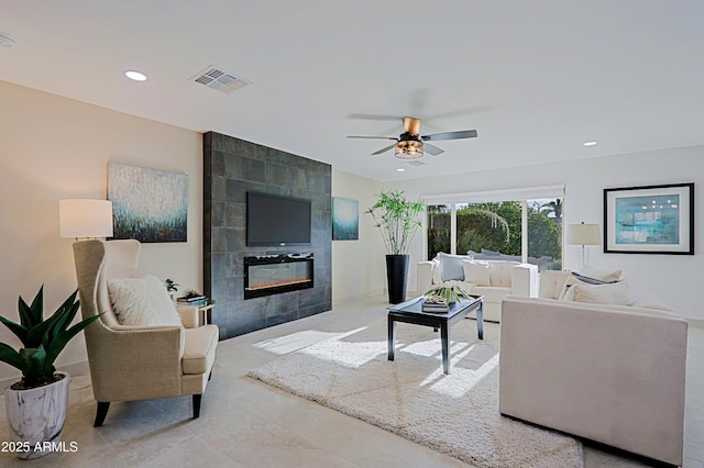 living area featuring a ceiling fan, a tile fireplace, visible vents, and recessed lighting