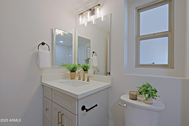 bathroom with toilet and vanity