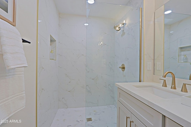 bathroom with a marble finish shower and vanity