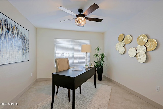 home office featuring a ceiling fan and baseboards