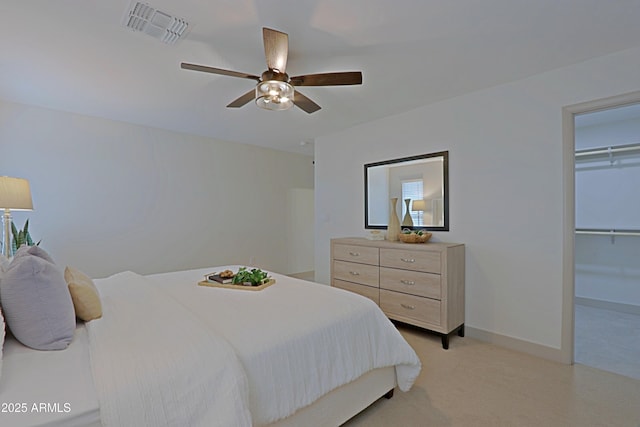 bedroom with light colored carpet, a ceiling fan, baseboards, visible vents, and a closet