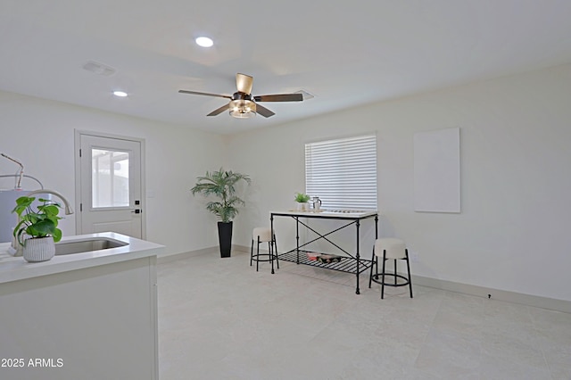 office space featuring recessed lighting, a sink, baseboards, and ceiling fan