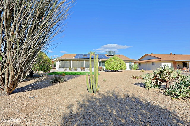 rear view of property with solar panels