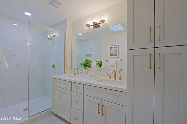 bathroom with double vanity, a marble finish shower, visible vents, and a sink