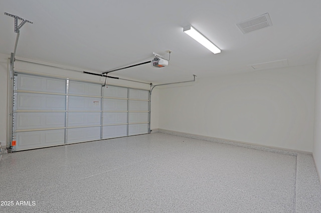 garage featuring visible vents and a garage door opener