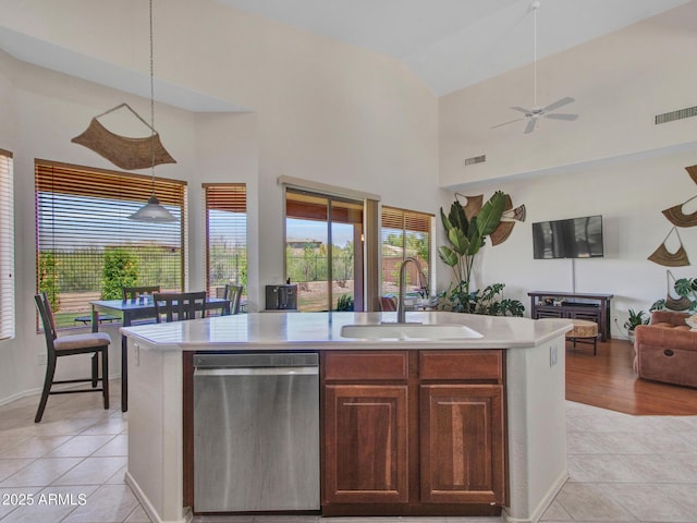 40814 N Majesty Ct, Anthem, AZ 85086 - kitchen with stainless steel dishwasher, open floor plan, light countertops, light tile patterned floors, and high vaulted ceiling